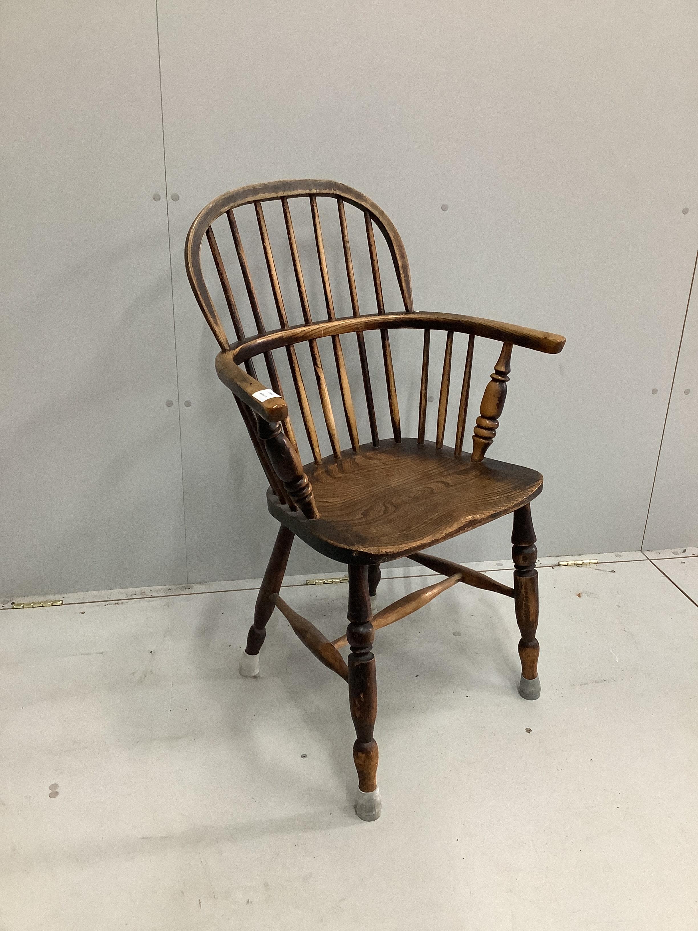 A mid 19th century Windsor elm and beech comb back elbow chair, width 62cm, depth 38cm, height 98cm
